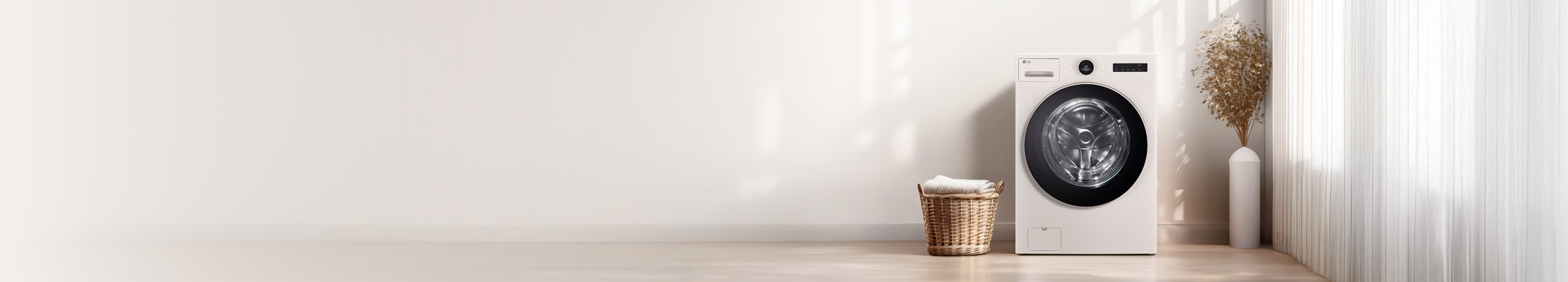 밝은 색상의 LG 세탁기가 실내 공간에 놓여 있으며, 옆에는 빨래 바구니와 장식용 꽃병이 있습니다.