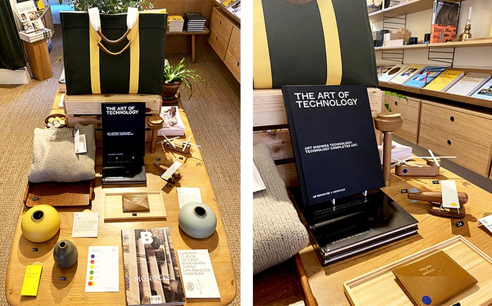 런던 모노클 매장 중앙 디스플레이 테이블에 『The Art of Technology』 책이 전시되어 있다. 블랙 커버의 책이 스탠드에 세워져 있으며, 주변에는 다양한 디자인 소품과 잡지가 함께 배치되어 있다. 니트 제품, 도자기 화병, 우드 소재의 비행기 장난감, 가죽 카드지갑 등이 정돈된 형태로 놓여 있어 감각적인 분위기를 연출한다.(왼쪽이미지) 런던 모노클 매장 중앙 테이블에서 『The Art of Technology』 책이 독립적으로 세워져 전시되어 있다. 책 주변에는 다양한 디자인 소품과 인테리어 소품들이 함께 진열되어 있으며, 우드 소재의 테이블과 따뜻한 조명이 매장의 세련된 분위기를 강조한다.(오른쪽이미지)